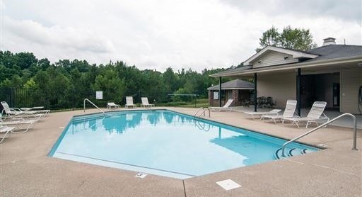 7211 Rye Court Fairview, TN 37062 - Photo 22 of 34 a view of swimming pool with outdoor seating and house in the background