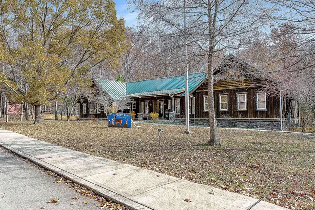 a view of a large house with a yard and large tree