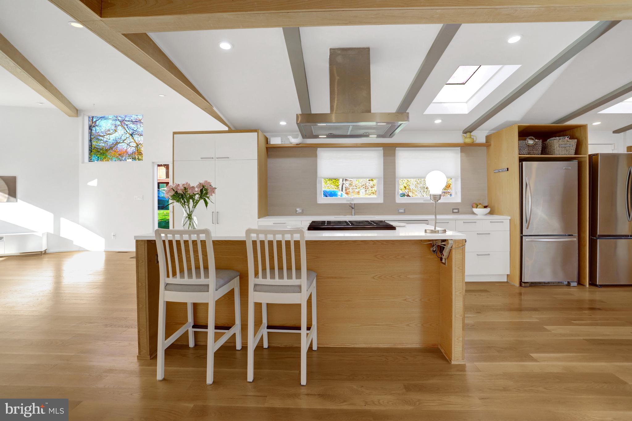 3017 Pine Spring Road Falls Church, VA 22042 - Photo 18 of 62 a kitchen with stainless steel appliances kitchen island granite countertop a dining table chairs and a refrigerator