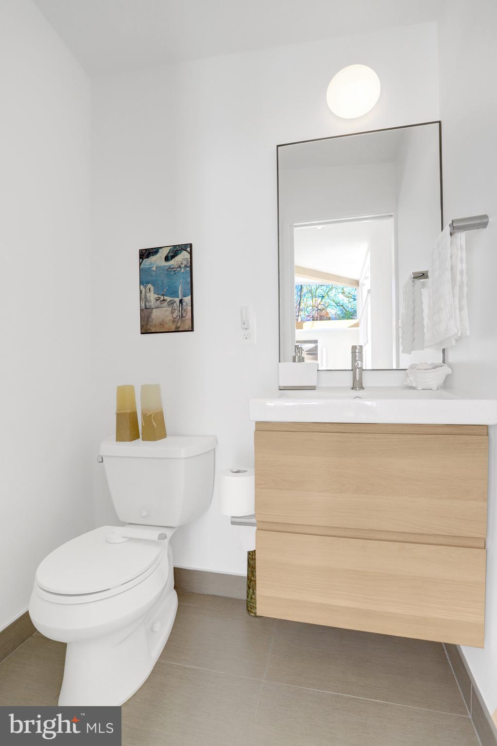 3017 Pine Spring Road Falls Church, VA 22042 - Photo 52 of 62 a bathroom with a toilet a sink and a mirror