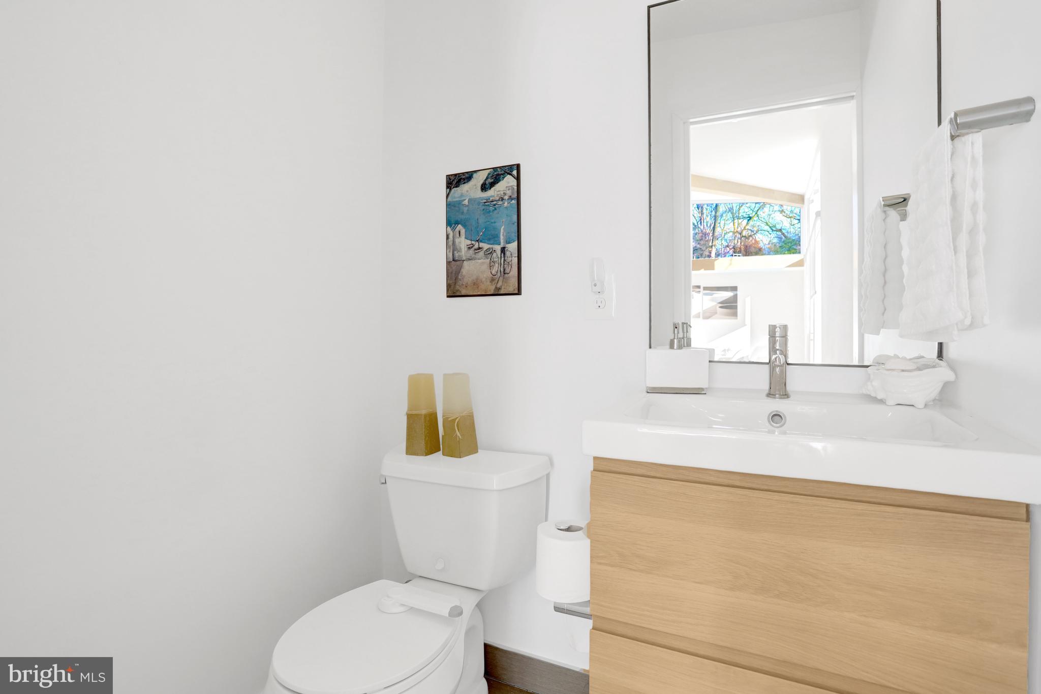 3017 Pine Spring Road Falls Church, VA 22042 - Photo 53 of 62 a bathroom with a toilet sink and mirror