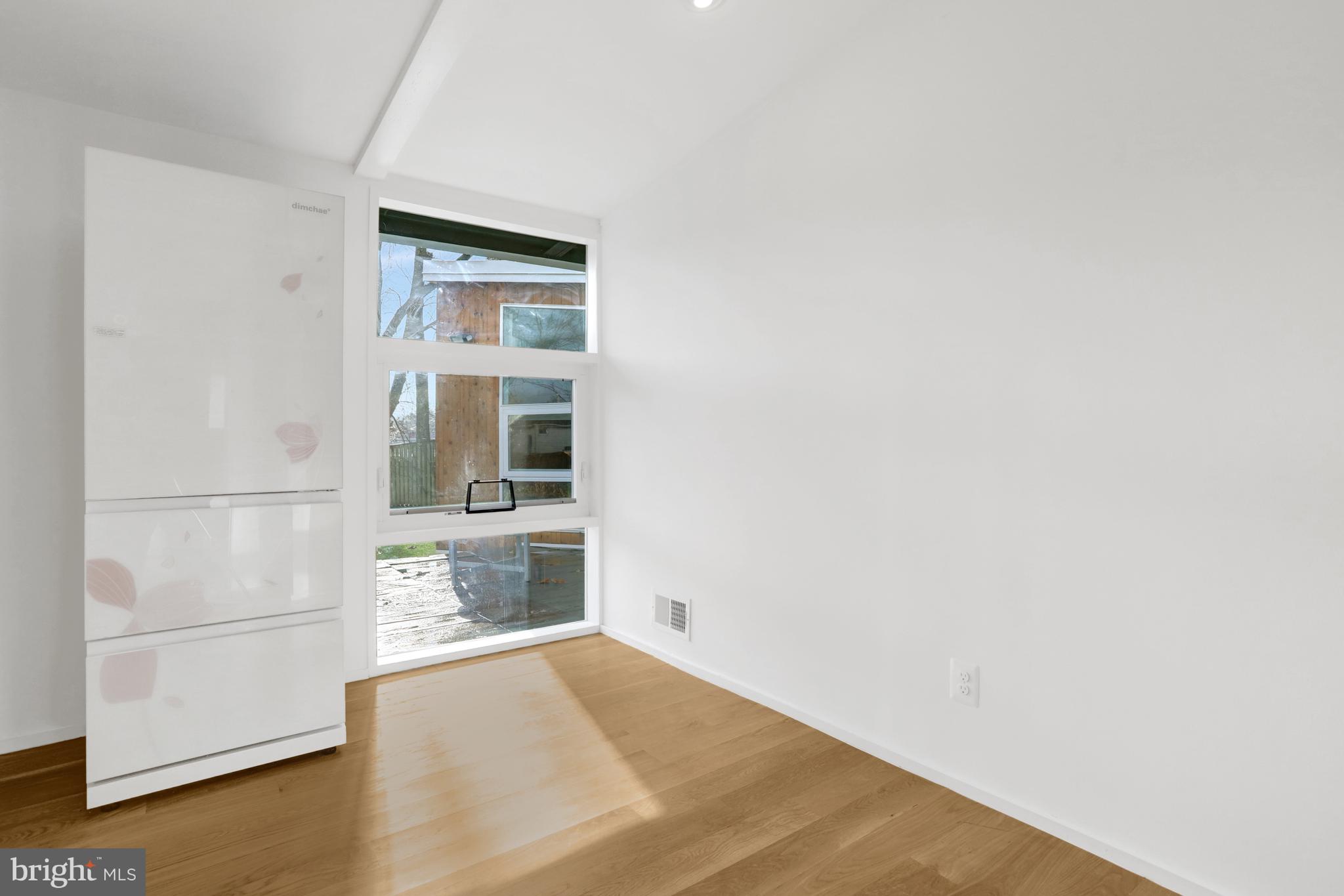 3017 Pine Spring Road Falls Church, VA 22042 - Photo 6 of 62 a view of an empty room with a window and wooden floor
