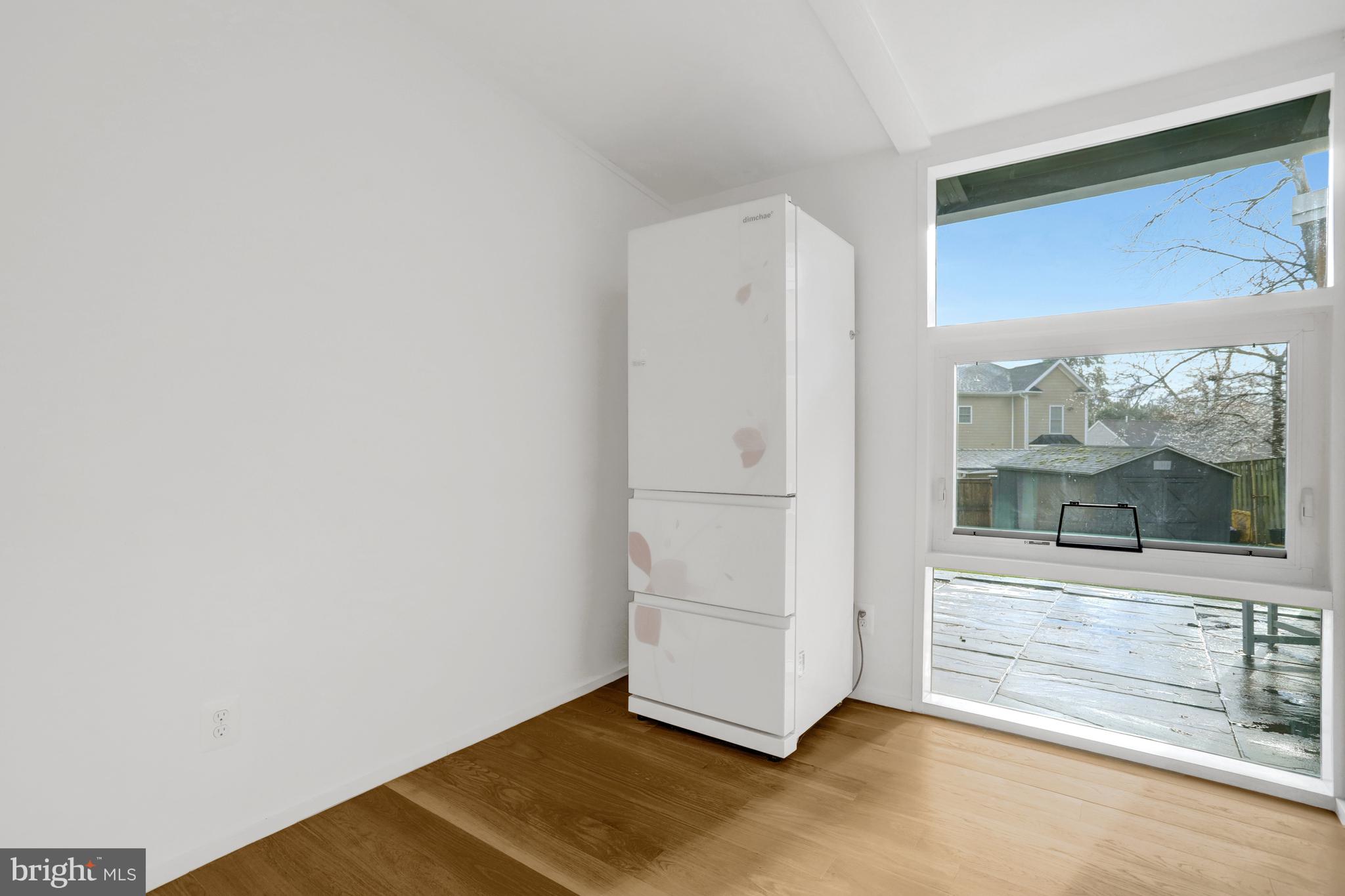 3017 Pine Spring Road Falls Church, VA 22042 - Photo 9 of 62 a view of an empty room with wooden floor and a window