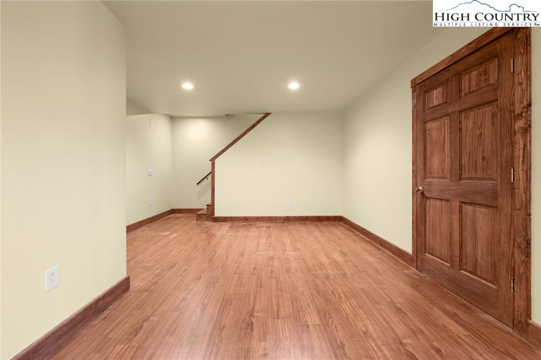 304 Glendale Drive Boone, NC 28607 - Photo 44 of 50 an empty room with wooden floor and windows