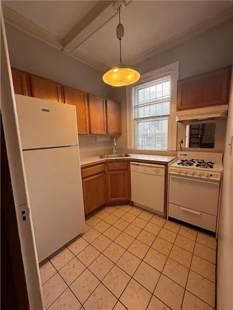 a kitchen with a refrigerator a stove top oven a sink and dishwasher