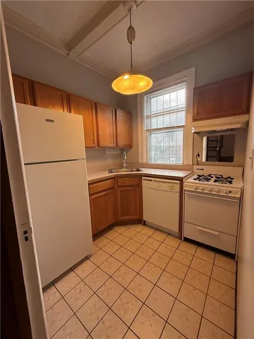 a kitchen with a refrigerator a stove top oven a sink and dishwasher