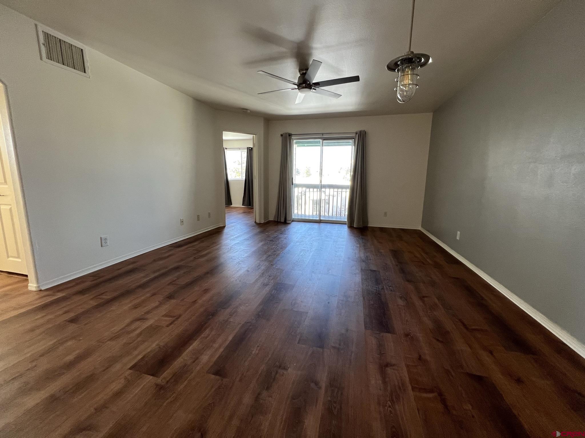 1100 Goeglein Gulch Road, Unit 223 Durango, CO 81301 - Photo 2 of 25 wooden floor in an empty room with a window
