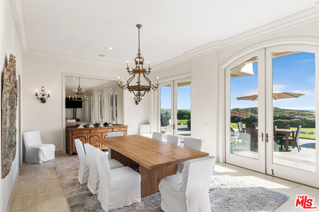 0 Broad Beach Road Malibu, CA 90265 - Photo 22 of 54 a view of a dining room with furniture wooden floor and chandelier