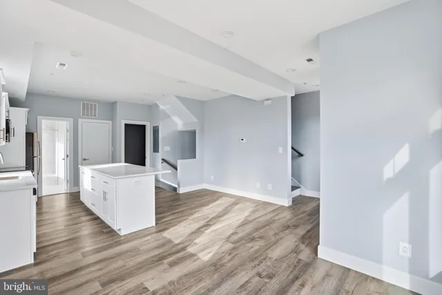 a view of kitchen with furniture and wooden floor