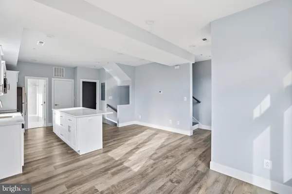 a view of kitchen with furniture and wooden floor