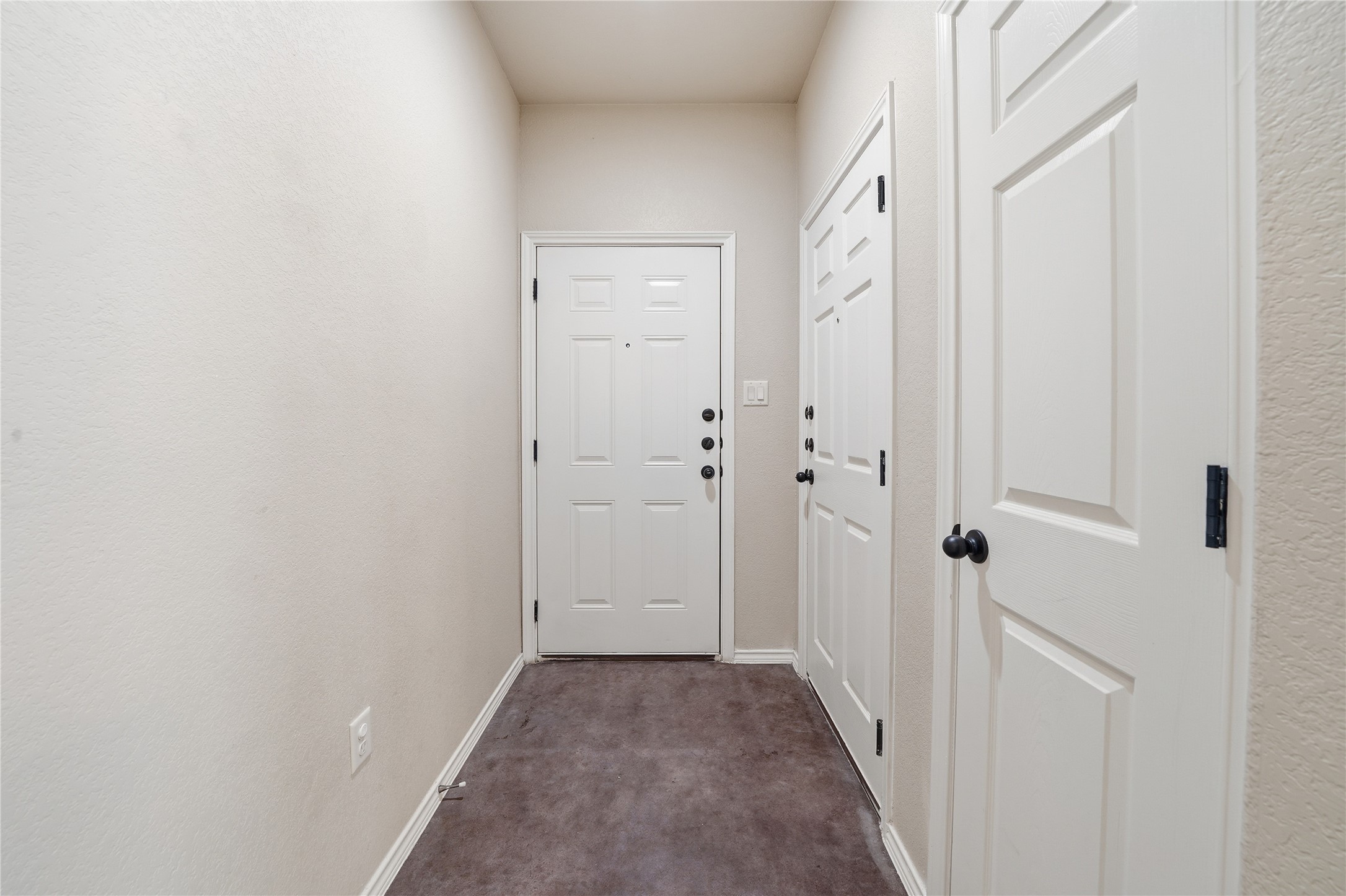 533 Jack Rabbit Lane, Unit A Buda, TX 78610 - Photo 8 of 34 A well-maintained entryway welcomes you home with durable carpet and classic white doors.