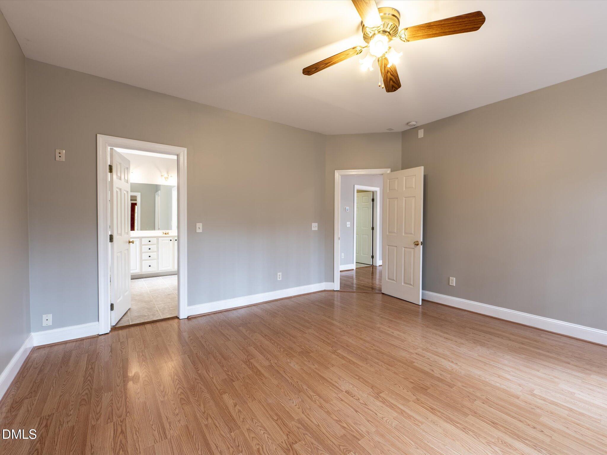 6832 Cool Pond Road Raleigh, NC 27613 - Photo 11 of 27 a view of an empty room with window and wooden floor
