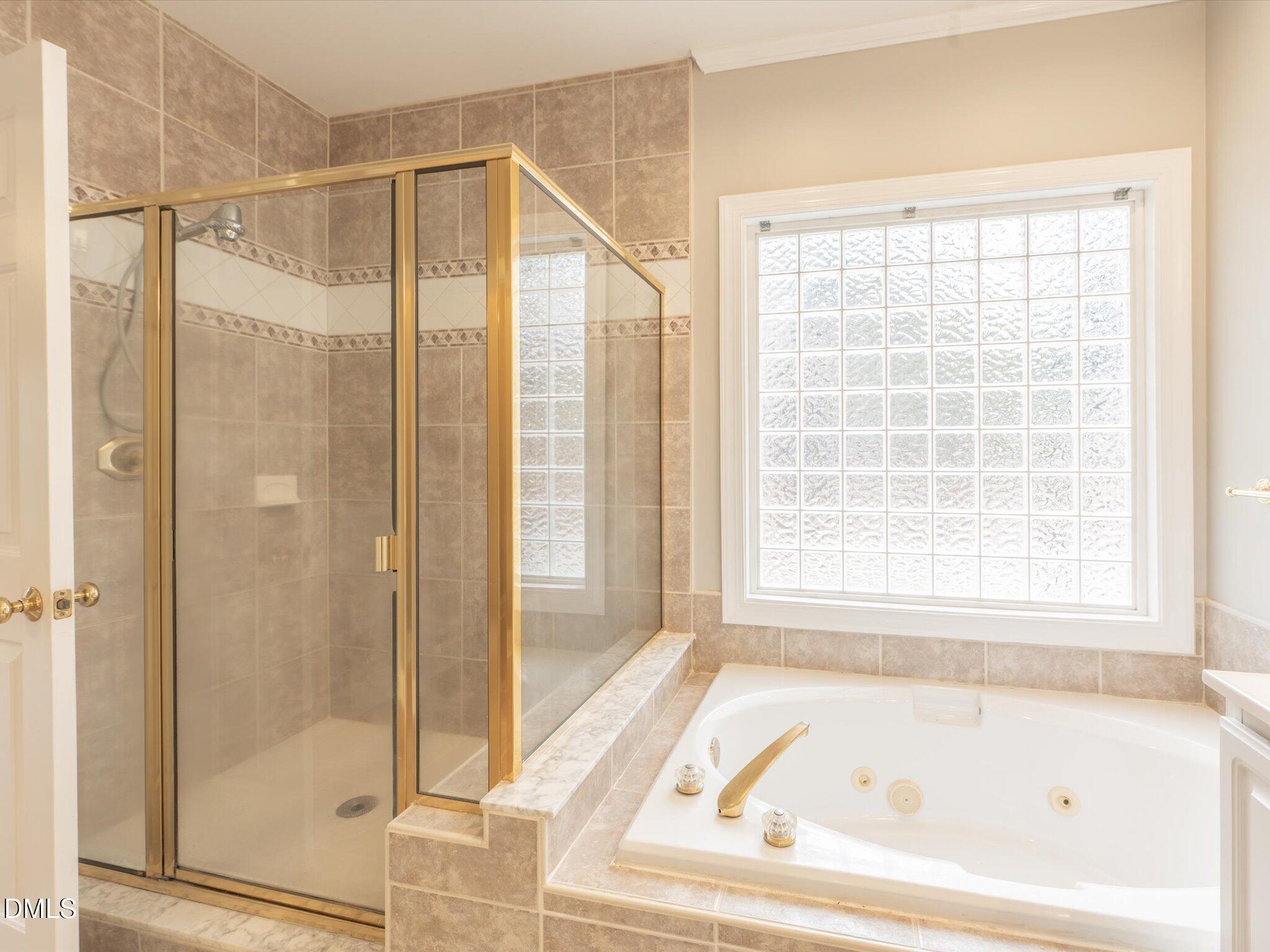 6832 Cool Pond Road Raleigh, NC 27613 - Photo 13 of 27 a bathroom with a bathtub and a shower