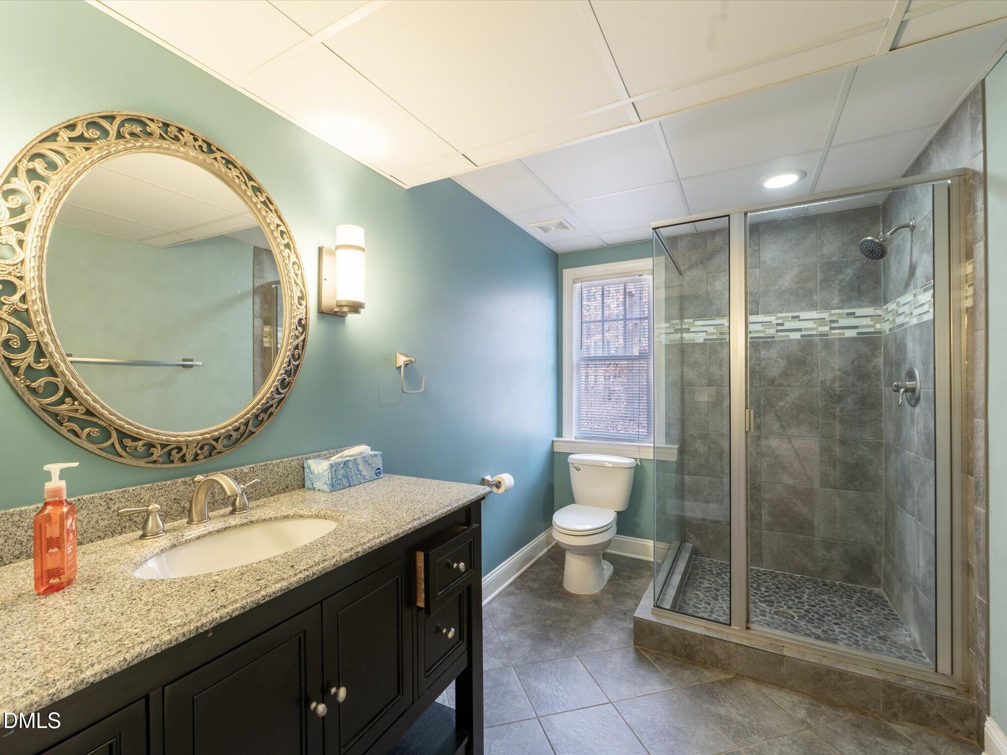 6832 Cool Pond Road Raleigh, NC 27613 - Photo 15 of 27 a bathroom with a granite countertop sink mirror vanity and toilet