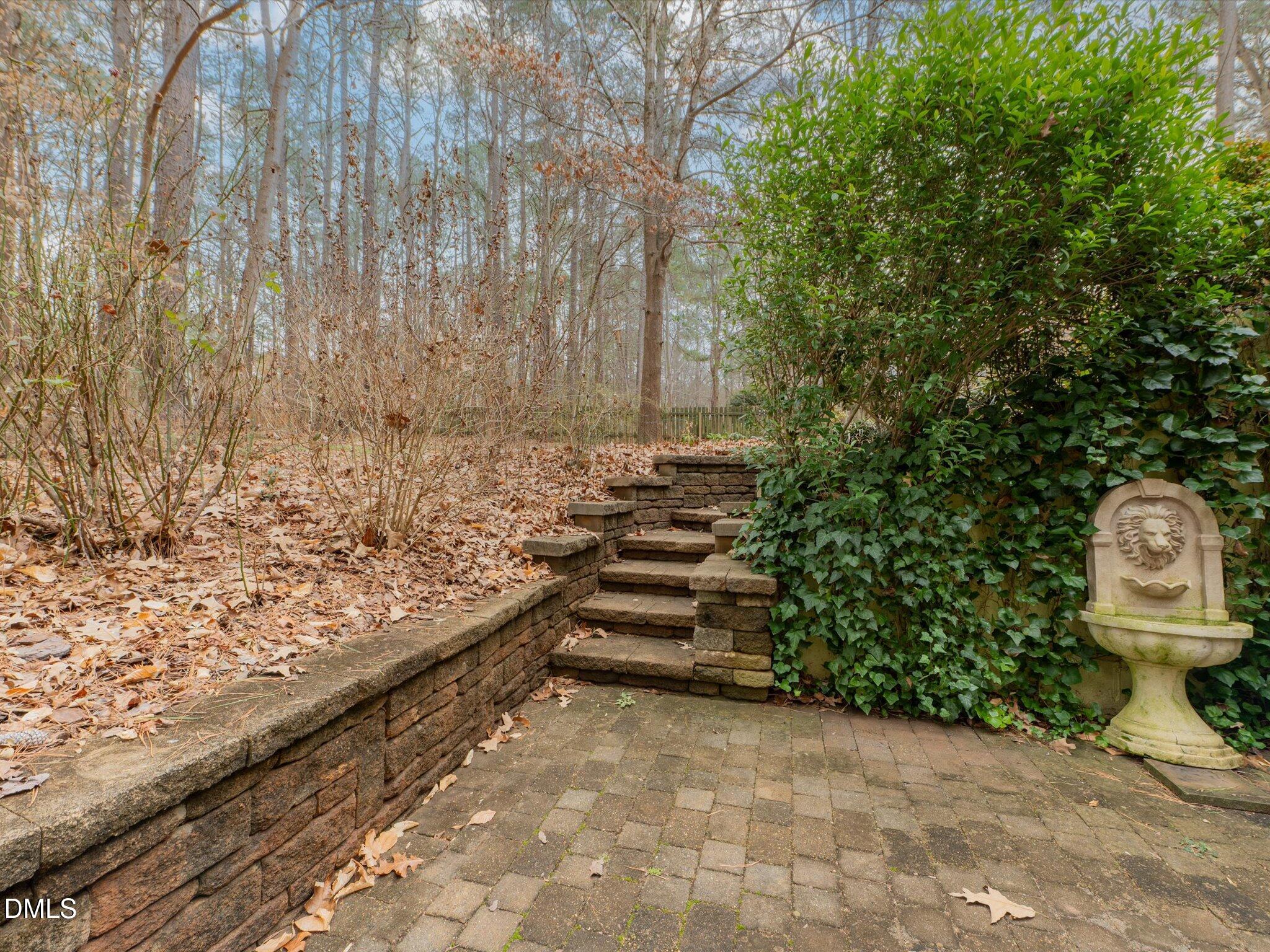6832 Cool Pond Road Raleigh, NC 27613 - Photo 18 of 27 a view of a backyard with wooden fence and a bench