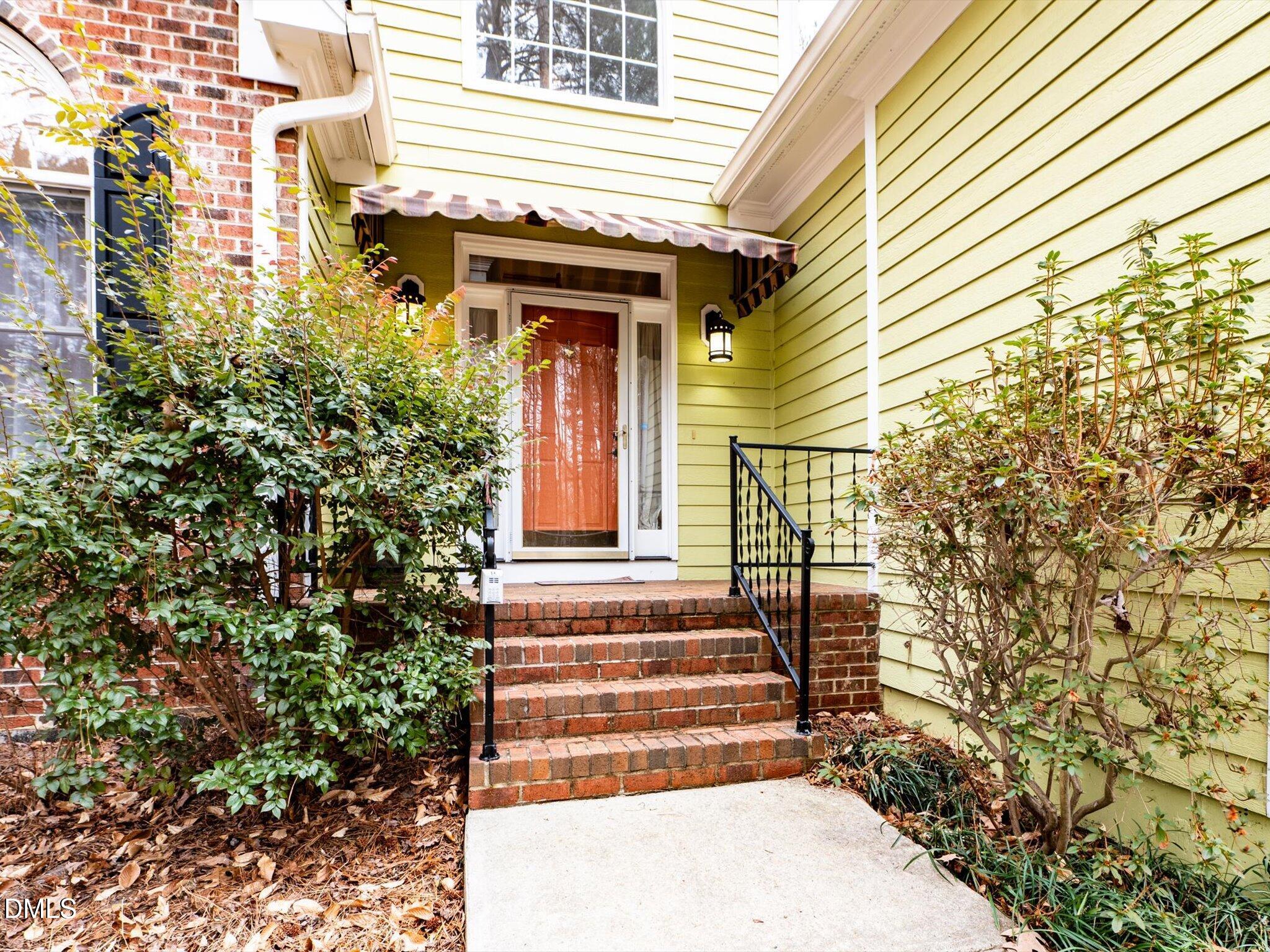 6832 Cool Pond Road Raleigh, NC 27613 - Photo 2 of 27 a front view of a house with a garden