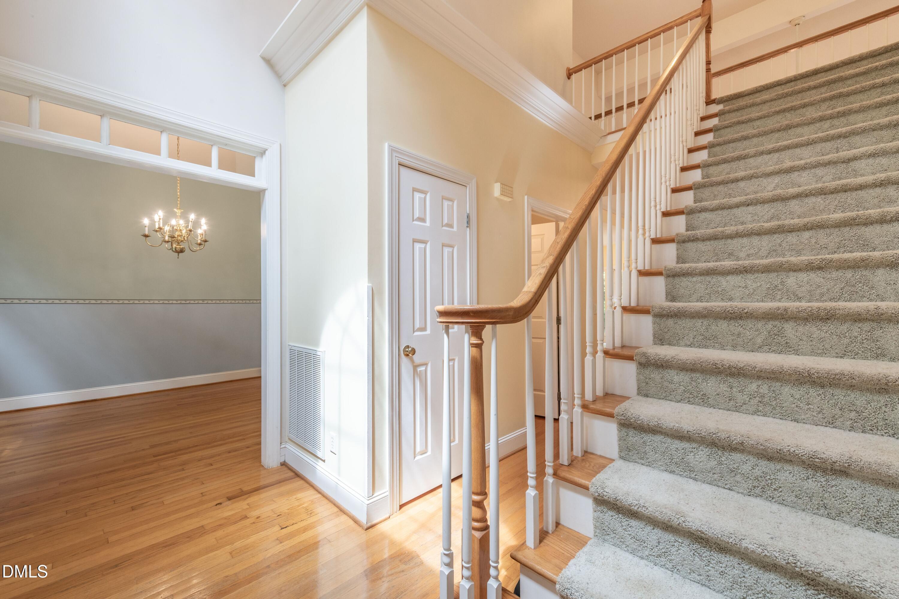 6832 Cool Pond Road Raleigh, NC 27613 - Photo 3 of 27 a view of staircase with white walls and railing
