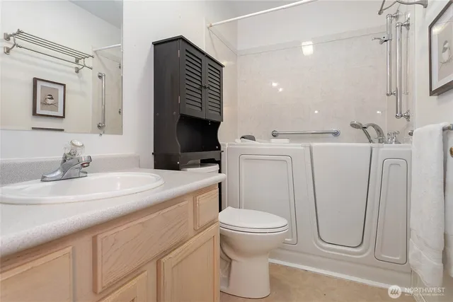 a bathroom with a toilet sink and mirror