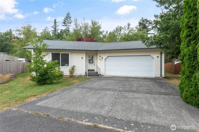 a front view of a house with a yard and a garage