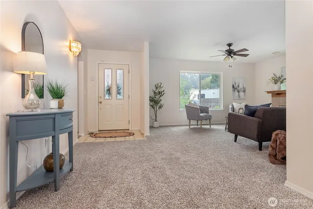 a living room with furniture and a chandelier