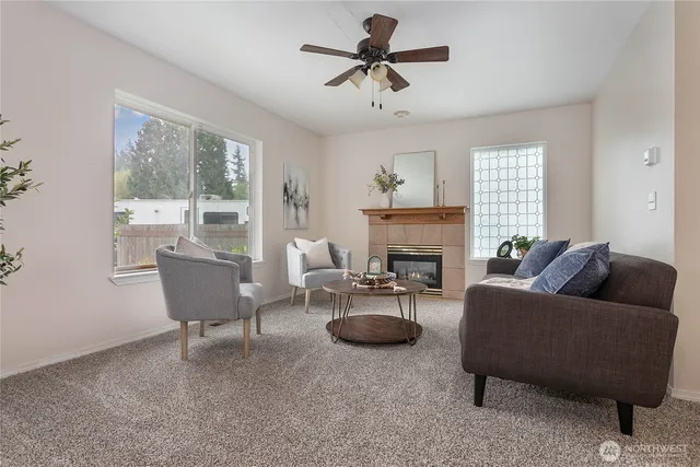 a living room with furniture a large window and a table