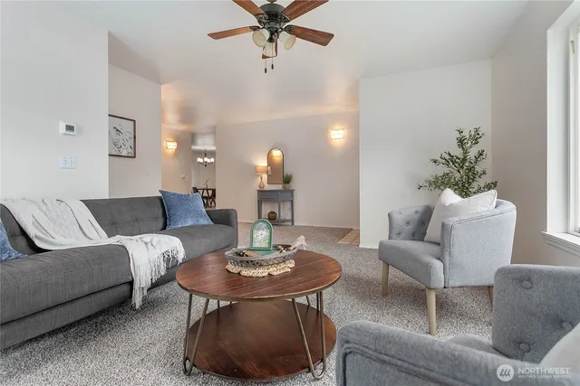 a living room with furniture and a chandelier