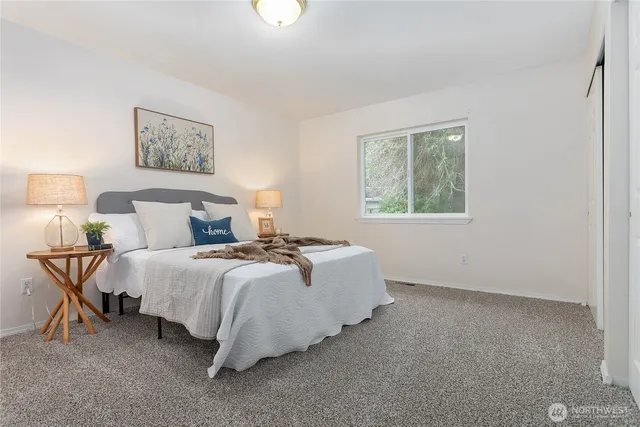 a bed room with a bed and a night stand