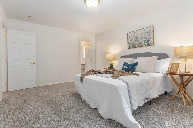 a bedroom with a bed and a night stand