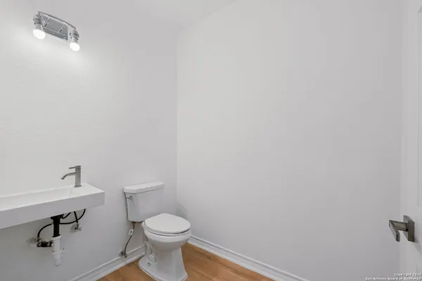 a white toilet sitting next to a bathroom sink