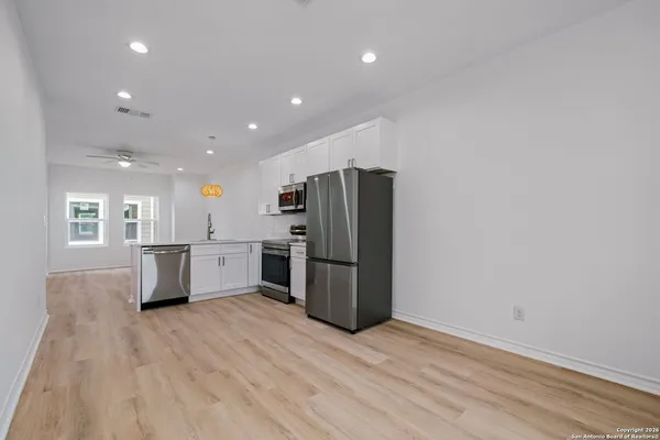 a kitchen with stainless steel appliances a refrigerator and a sink