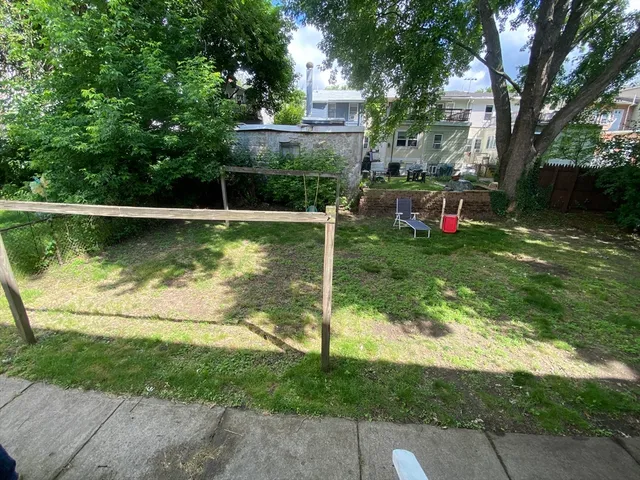 a view of a wooden deck and a yard