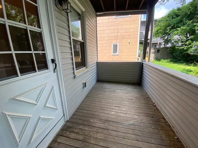 a view of balcony with wooden floor and fence