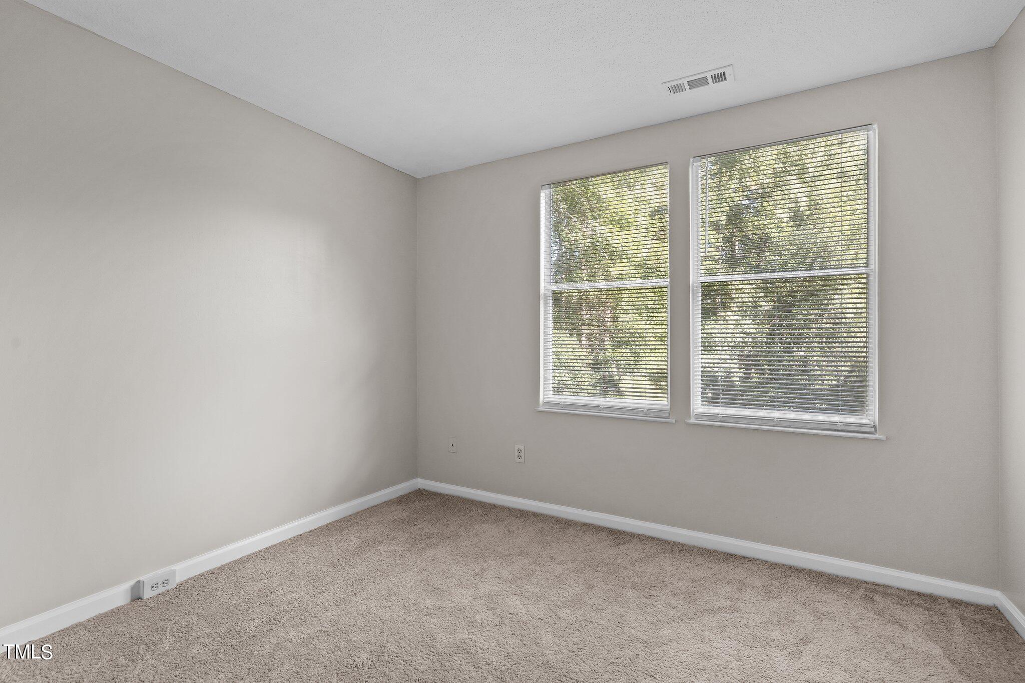 7837 Stephanie Lane Raleigh, NC 27615 - Photo 15 of 27 an empty room with a window