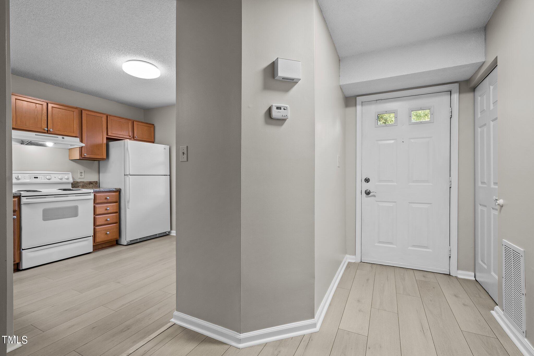 7837 Stephanie Lane Raleigh, NC 27615 - Photo 2 of 27 a view of a kitchen with a white cabinet and a stove top oven