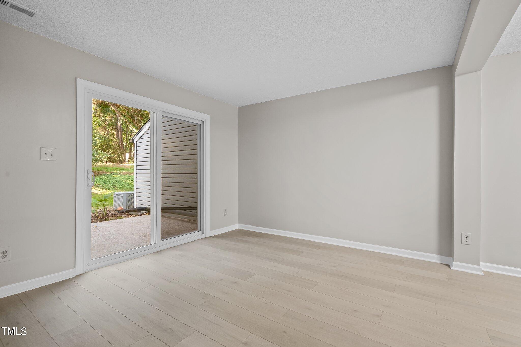 7837 Stephanie Lane Raleigh, NC 27615 - Photo 8 of 27 a view of an empty room with a window