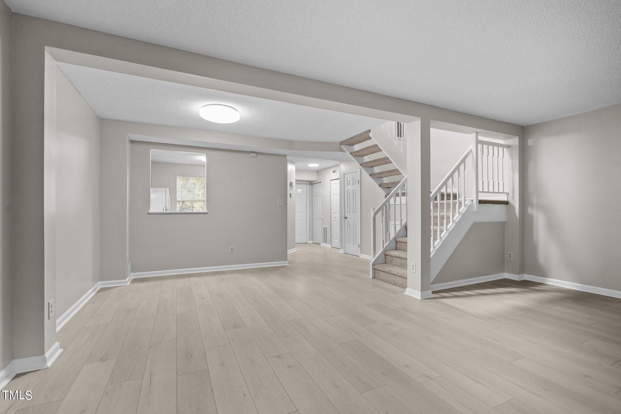 7837 Stephanie Lane Raleigh, NC 27615 - Photo 10 of 27 a view of an empty room with a window