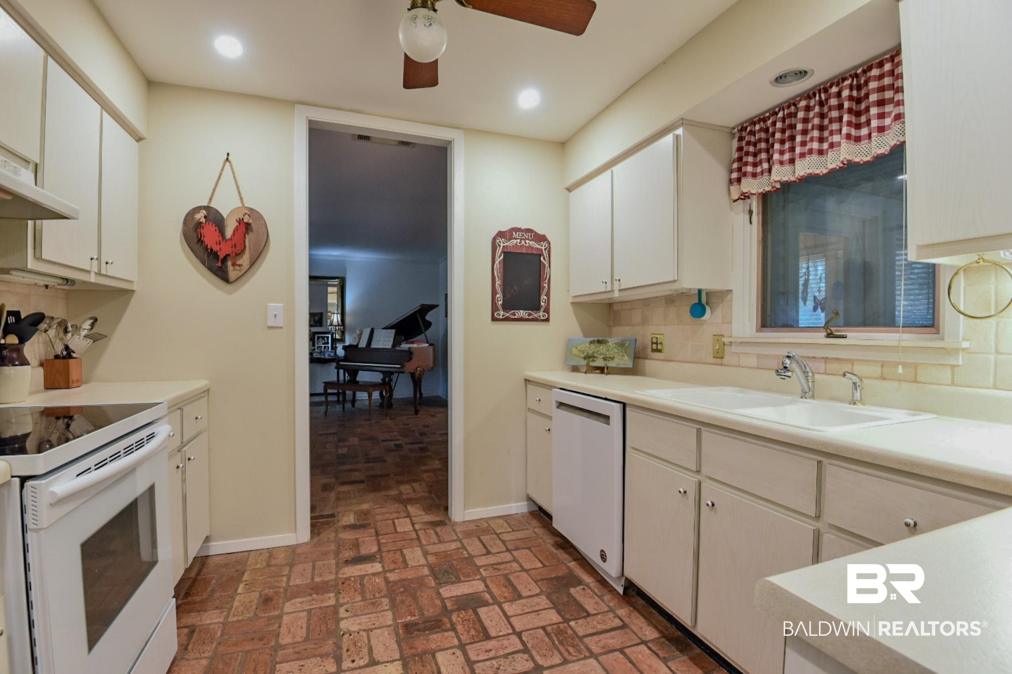 90 Paddock Drive Fairhope, AL 36532 - Photo 8 of 23 Kitchen with white appliances, light countertops, backsplash, brick flooring, and a ceiling fan