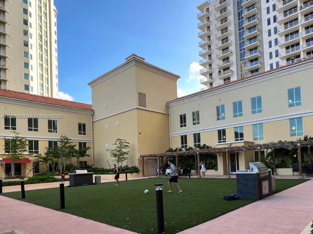 a front view of a building with a garden