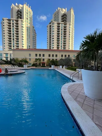 a view of a swimming pool with outdoor seating