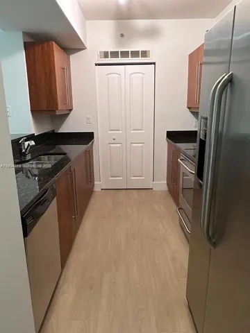 a kitchen with a refrigerator stove and a sink