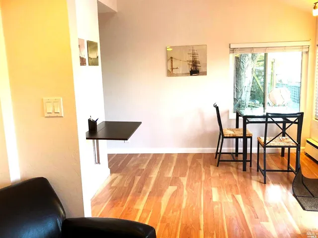 a view of dining room and kitchen with a wooden floor