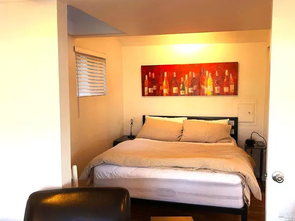 a bed sitting in a bedroom next to a window