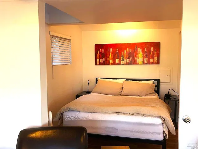 a bed sitting in a bedroom next to a window