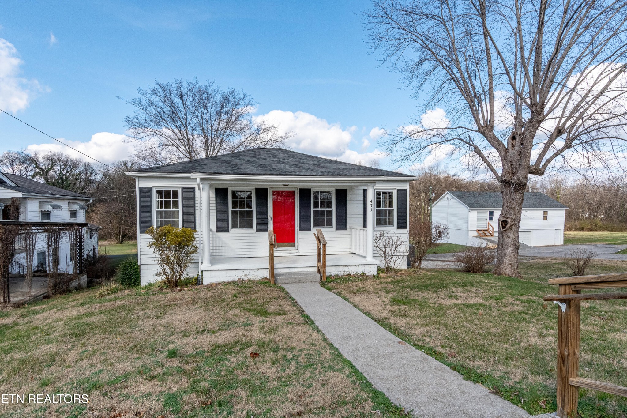 a front view of a house with a yard and seating space