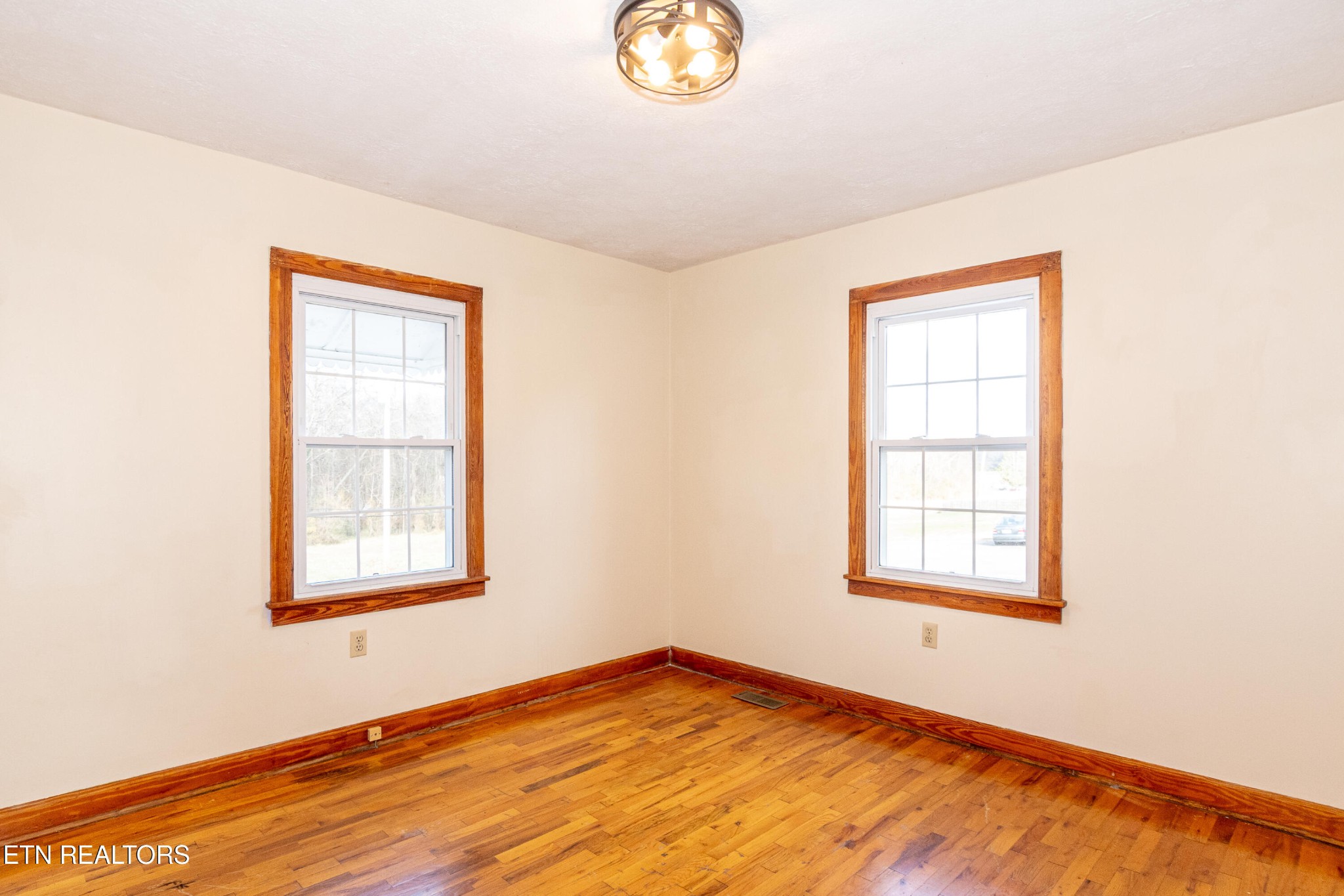 471 East Lincoln Road Alcoa, TN 37701 - Photo 15 of 47 a view of an empty room with window and wooden floor