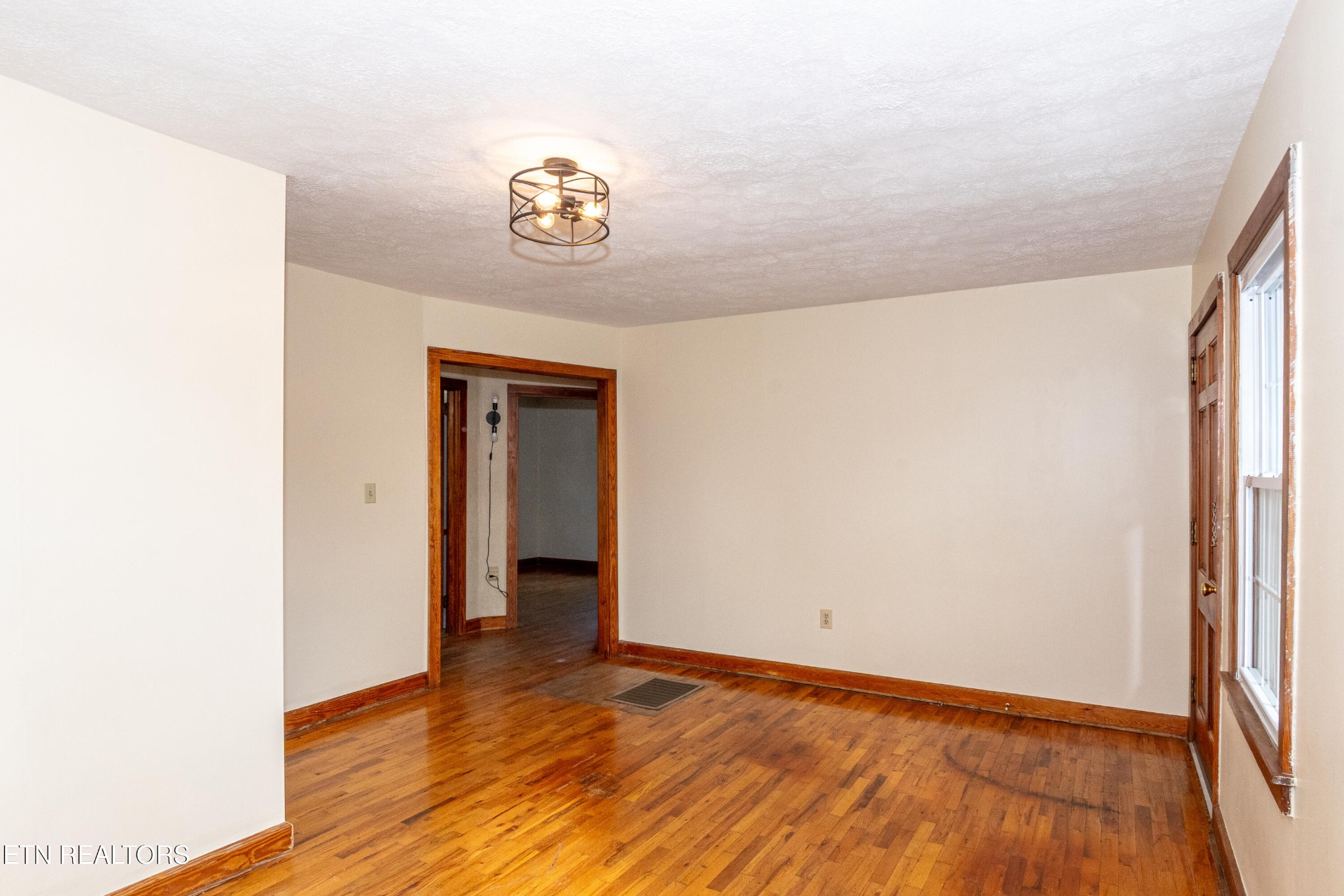 471 East Lincoln Road Alcoa, TN 37701 - Photo 6 of 47 a view of an empty room with wooden floor and a window