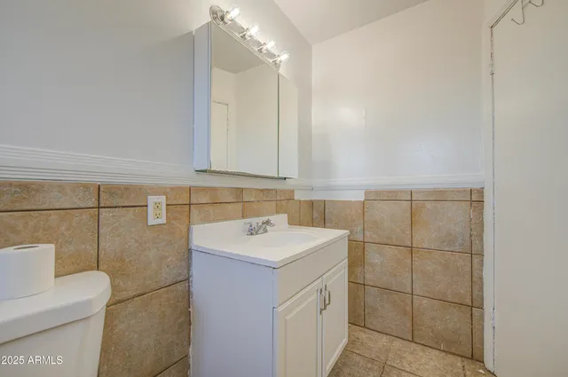 a view of a yard with an empty space and wooden fence