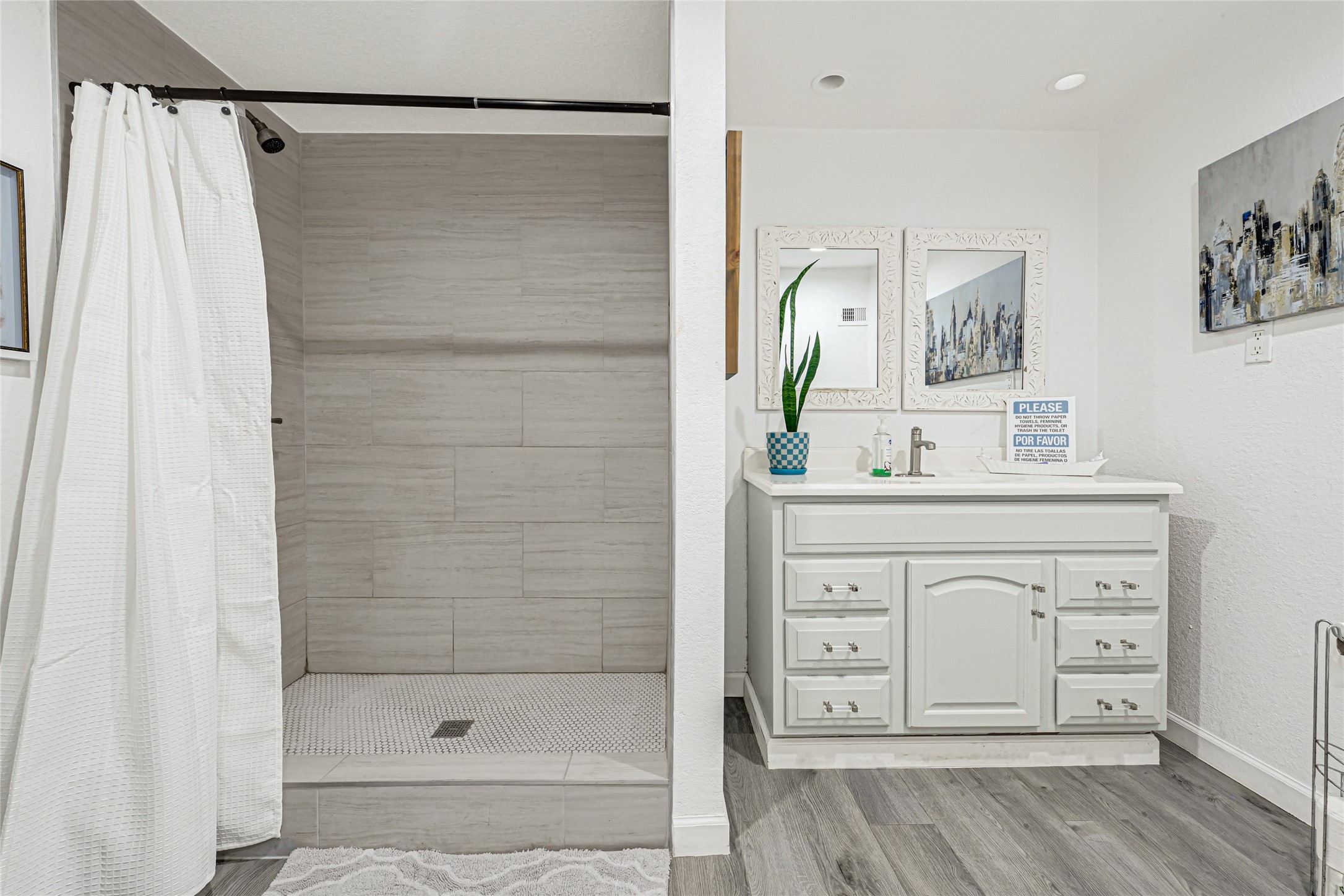 2809 Tooke Street Houston, TX 77023 - Photo 9 of 50 a bathroom with a shower sink and mirror