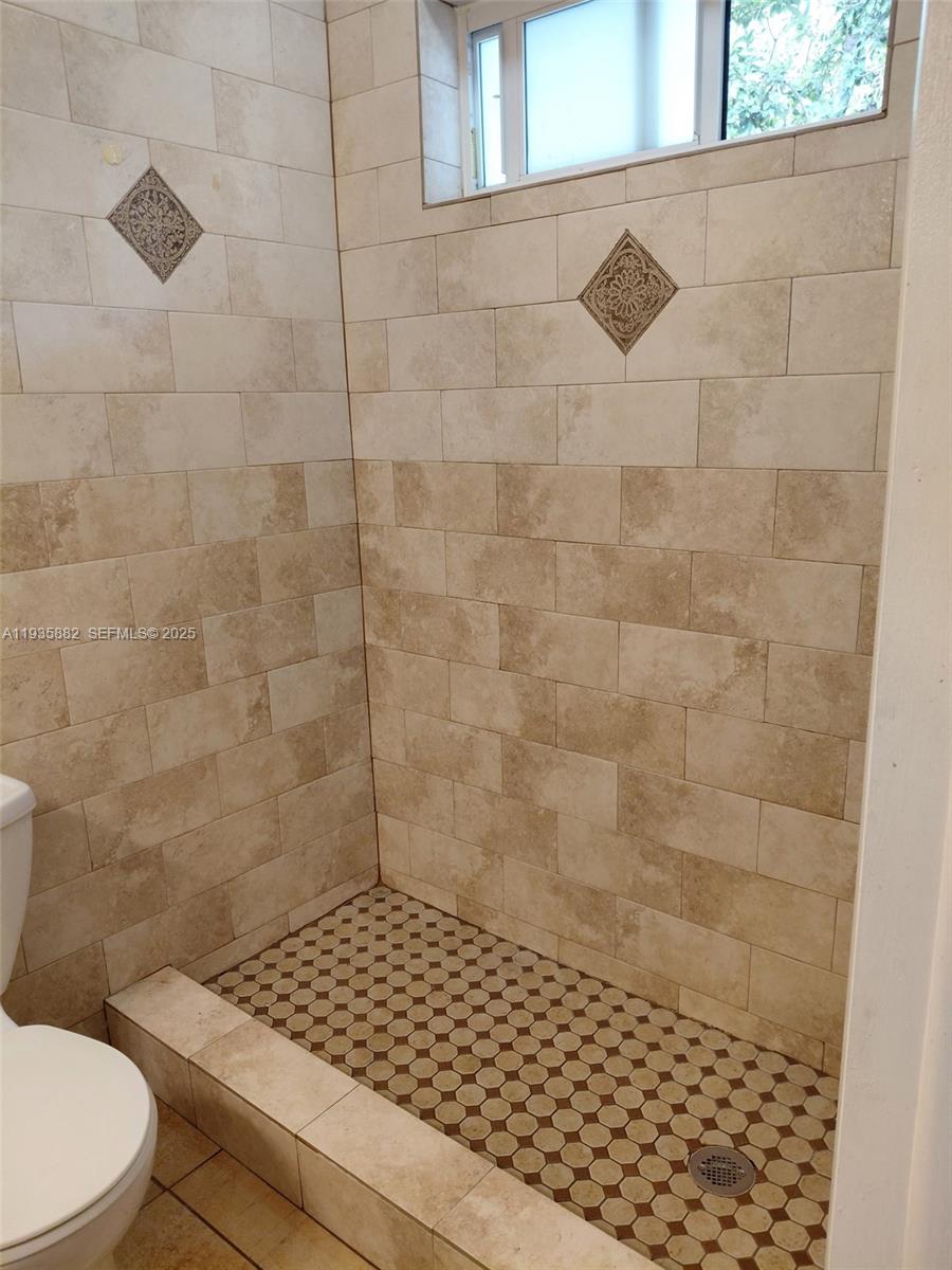 3503 Southwest 24th Street, Unit 3503 Miami, FL 33145 - Photo 5 of 12 a bathroom with a toilet and a shower