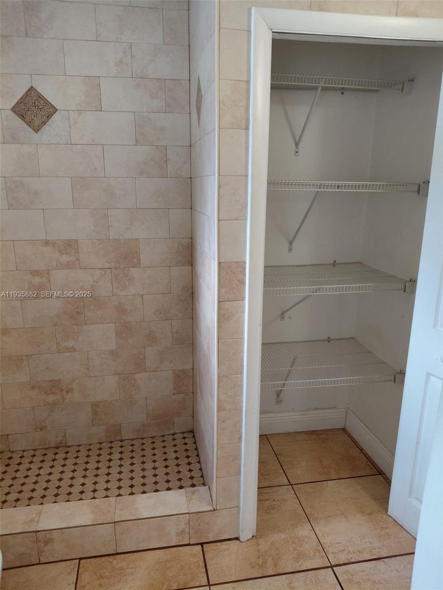 3503 Southwest 24th Street, Unit 3503 Miami, FL 33145 - Photo 6 of 12 a bathroom with a glass door shower